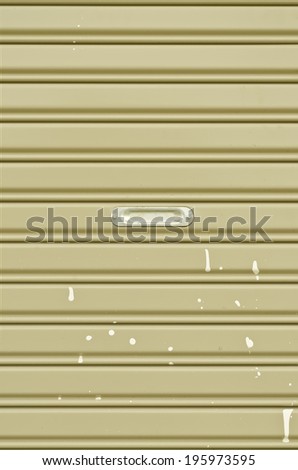 Dirty corrugated metal sheet slide door