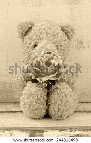 still life photography of cute bear doll holding rose bouquet in vintage style