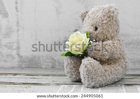 cute bear doll holding rose bouquet