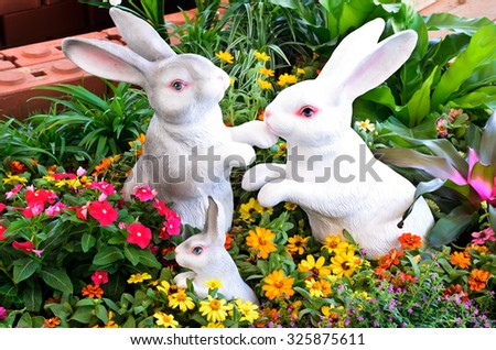 Three rabbit sculptures in garden