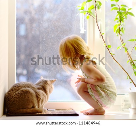 Cat And Girl Looking Out Of The Window