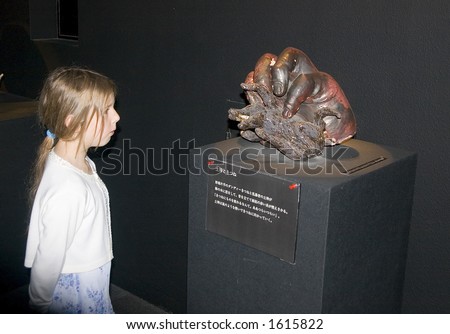 Teenage girl impressed by abstract sculpture, modern japanese art