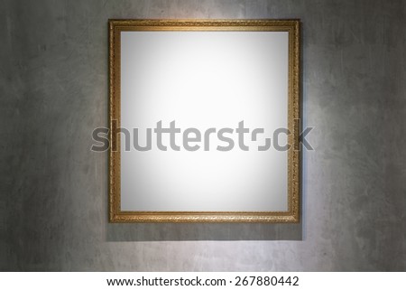 Antique golden frame on concrete wall in gallery