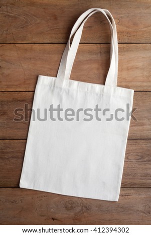 White fabric bag on wooden table