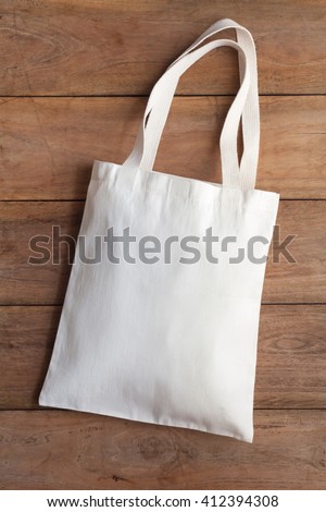 White fabric bag on wooden table