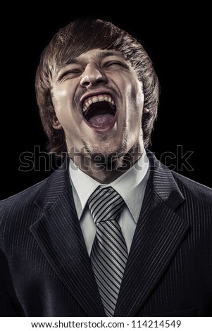 young successful businessman laughing hard over black