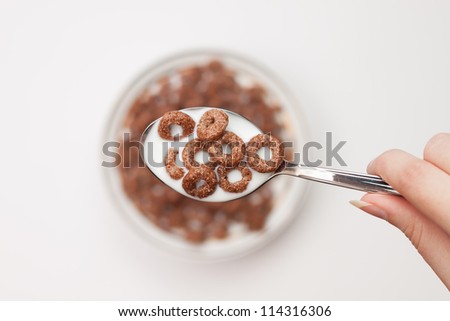 spoon full of chocolate ringlets in hand close-up breakfast concept