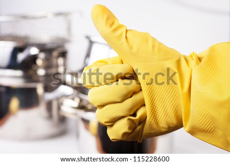 hand in protective glove showing thumb up