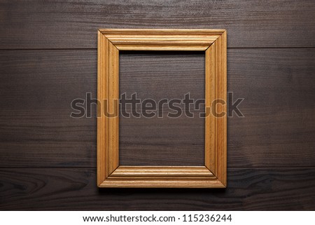 old empty frame over wooden background