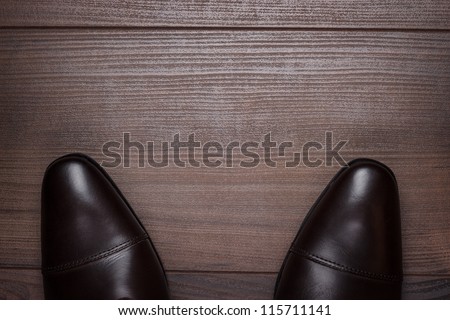 man standing on the wooden floor background