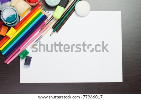 blank sheet of paper with colorful artist instruments creative process