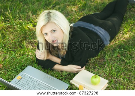 beautiful girl studying in park with laptop