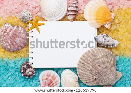 blue yellow pink bath salt and blank notepad background