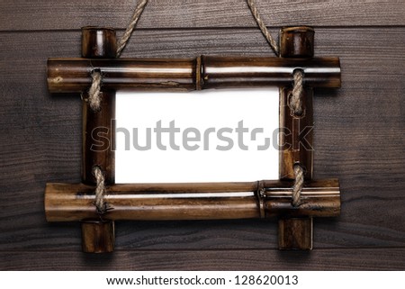old empty frame with copy space hanging on wooden wall