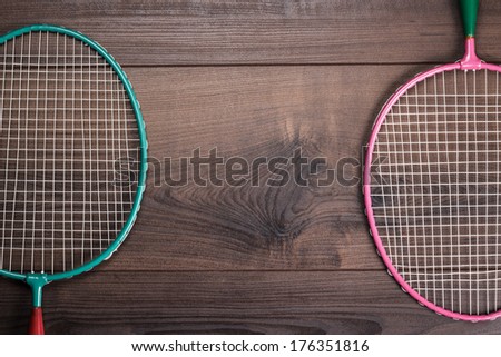 old badminton rackets on the wooden background