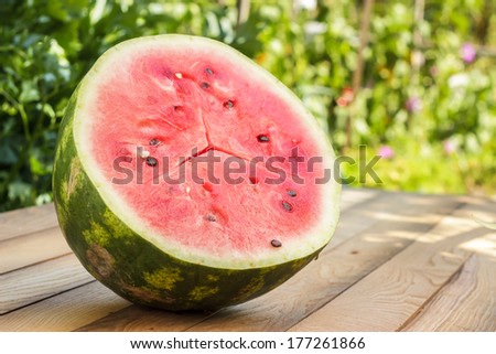half of watermelon on the wooden table