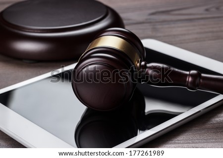 judge gavel and tablet computer on table cyber crime concept
