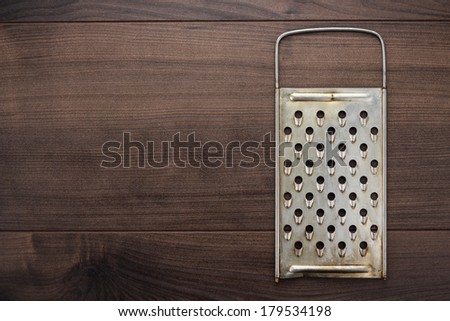 natural aged old rusted grater on the wooden table