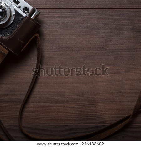 retro still camera in case on the wooden photographer\'s table