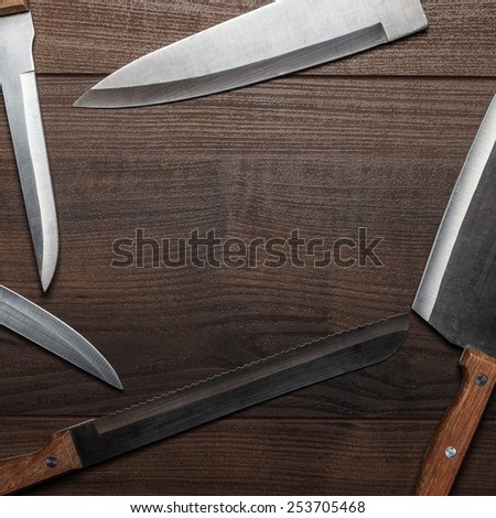 kitchen knifes on the brown wooden table background