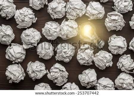new idea concept with crumpled office paper and light bulb