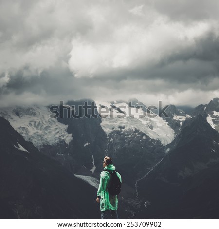 male traveller on the top of mountain stormy landscape