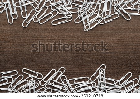white paper clips on the wooden table with copy space