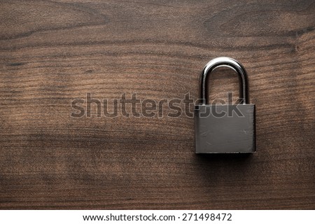 check-lock on the brown wooden table background