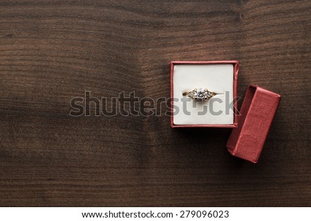 ring in the red box on wooden table