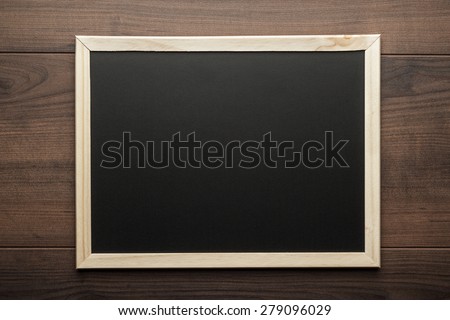 clean blackboard on the wooden table background