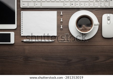 overhead of essential office objects in order on wooden desk with copy space