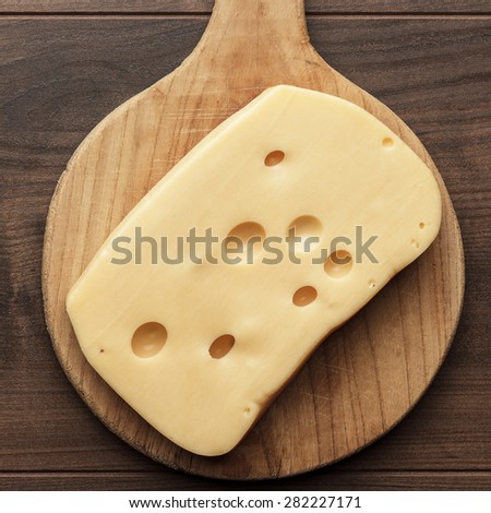 big pieces of cheese on wooden table