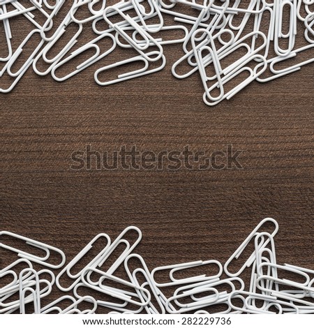 white paper clips on the wooden table with copy space
