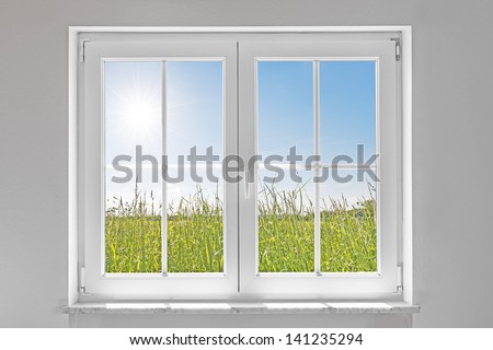 picture of a white wall with white closed window indoor and outside green meadow with sun and blue sky