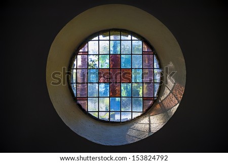 Picture of a colored church window with cross inside