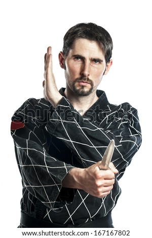 Man in combat dress do a self defense exercise with knife