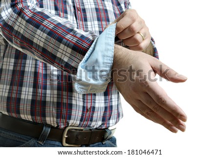 Man in jeans and a plaid shirt rolls up his sleeves, isolated on white background