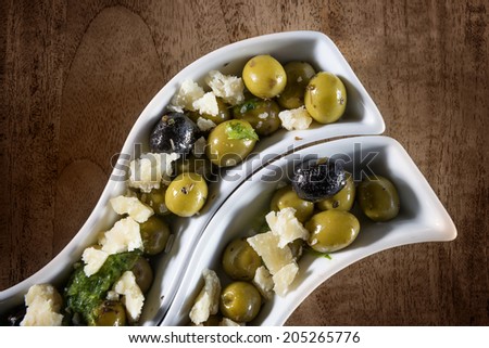 Two bowls with green and black olives