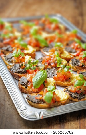 italian bruschetta with tomatoes, olive paste on a serving plate