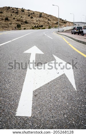 Image of a road with arrow road sign on mountain Jebel Akhdar in Oman