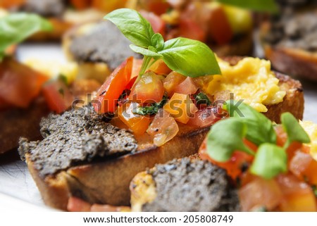 italian bruschetta with tomatoes, olive paste on a serving plate