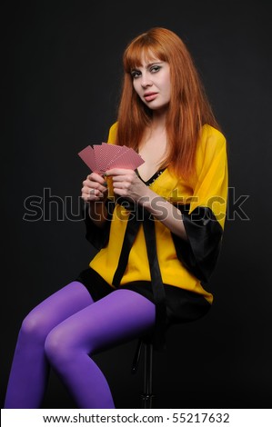 Beautiful red girl with playing cards