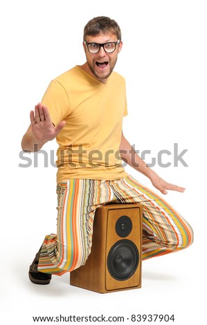 Cool funny dude dancing while sitting on the speaker white background, musical concept