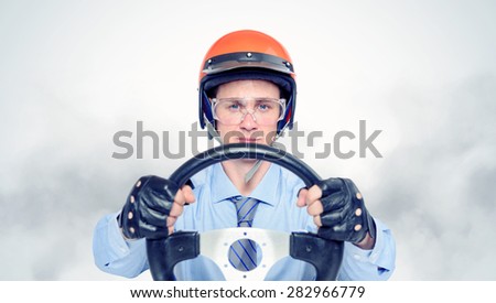Businessman in a red helmet with steering wheel, car drive concept