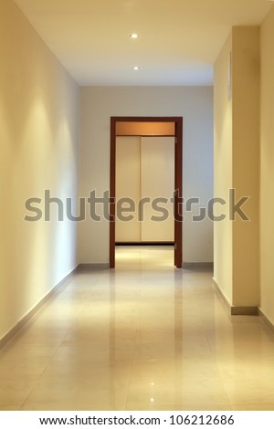 long and beautiful corridor with open door in a modern hotel, front