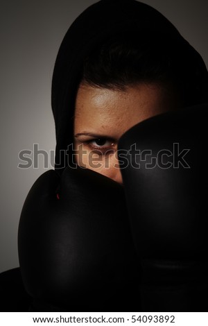 close-up portrait of girl with black boxing gloves