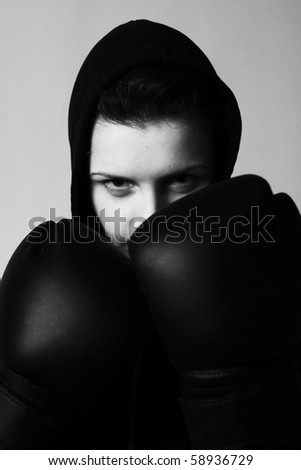 close-up portrait of girl with black boxing gloves