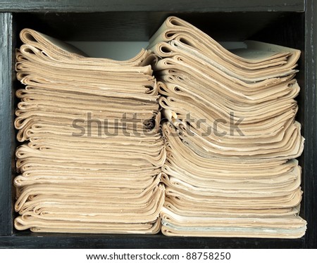 A stack of old newspapers, old, fat yellow.