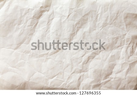 white sheet of paper folded and battered, with texture.