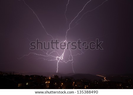 Beautiful powerful lightning over city, zipper and thunderstorm, dark sky with bright electrical flash, thunder and thunderbolt, bad weather concept